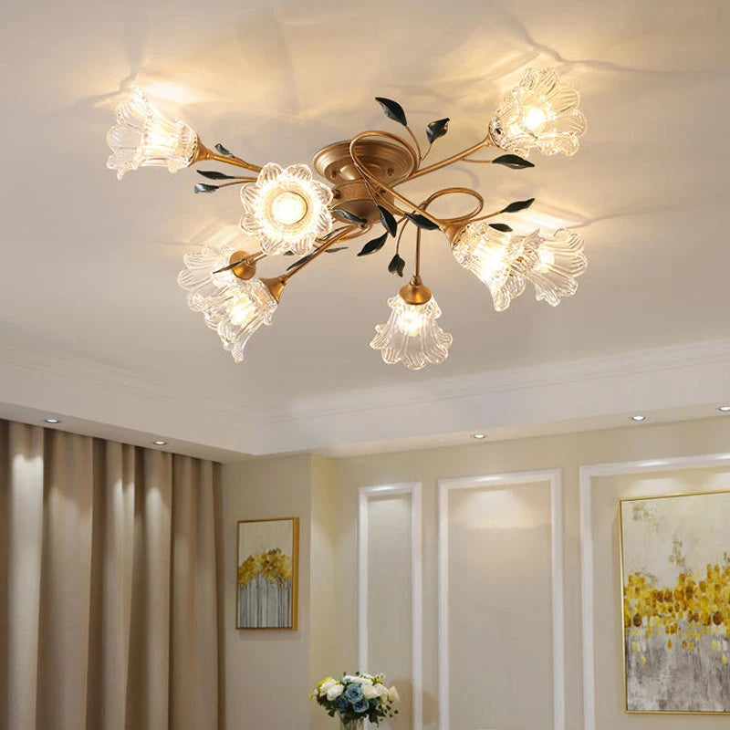 Gold floral semi-flush ceiling light installed in a well-decorated living room with curtains and artwork.