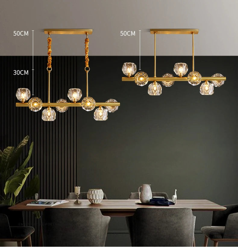 Gold chandelier with dimensions on a dark wall above a dining table.