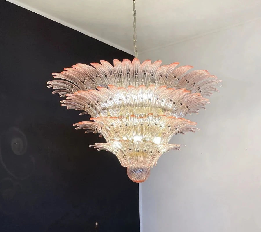 Decorative chandelier hanging against a black and white wall.