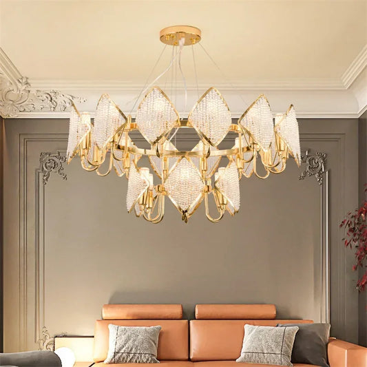 Close-up of a gold tiered chandelier with crystal details, mounted in a living room.