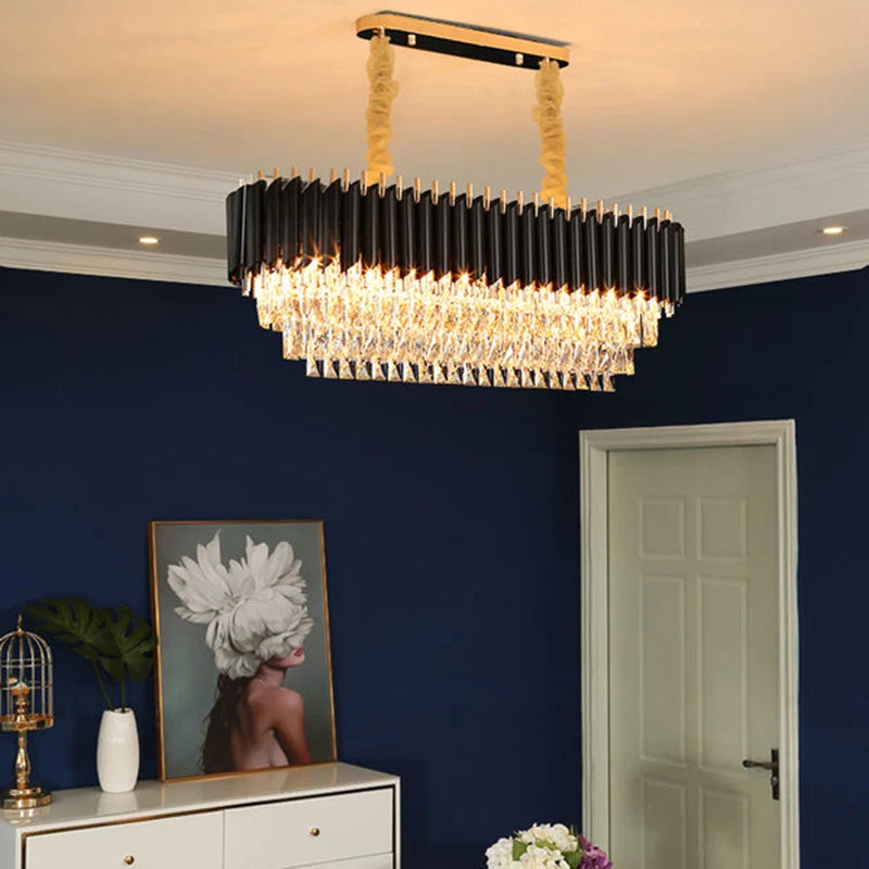 Modern chandelier hanging in a room with blue walls and decorative items.