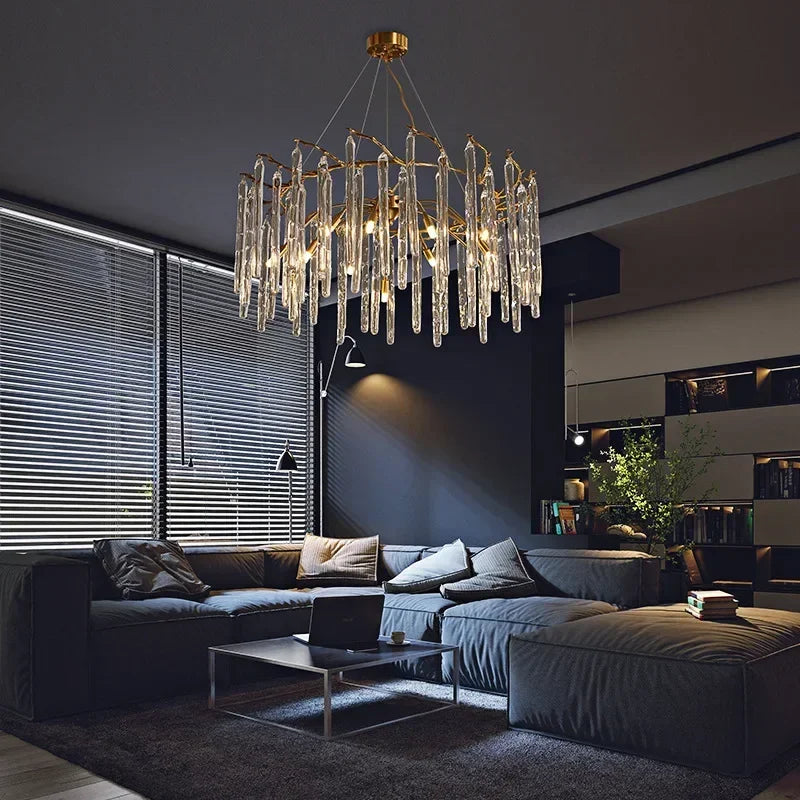 Modern living room with a luxurious chandelier, dark sofa, and coffee table.