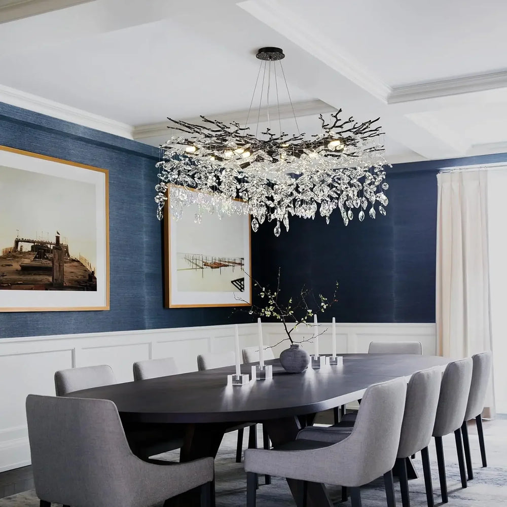 Dining room with a modern chandelier, dark wooden table, and gray chairs.