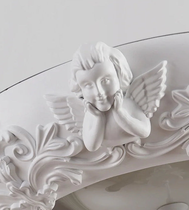 Decorative white angel figure with wings on a ceiling