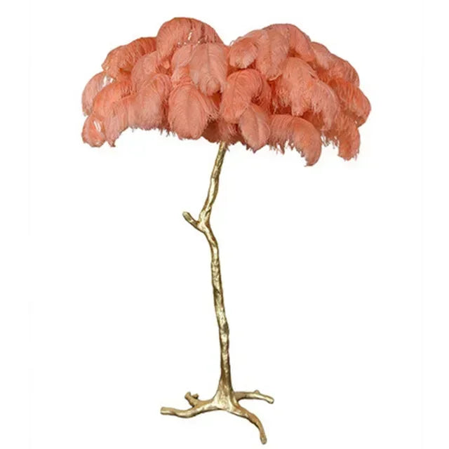 Pink feathered lamp with gold base on a white background