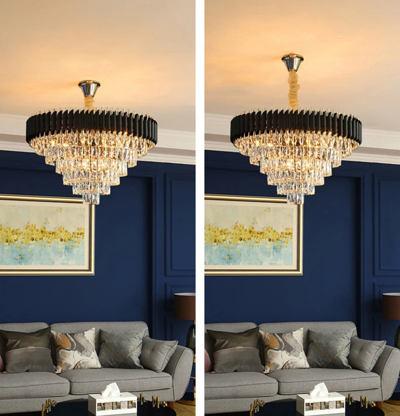 Chandelier hanging above a gray sofa with a blue wall and framed artwork in the background.