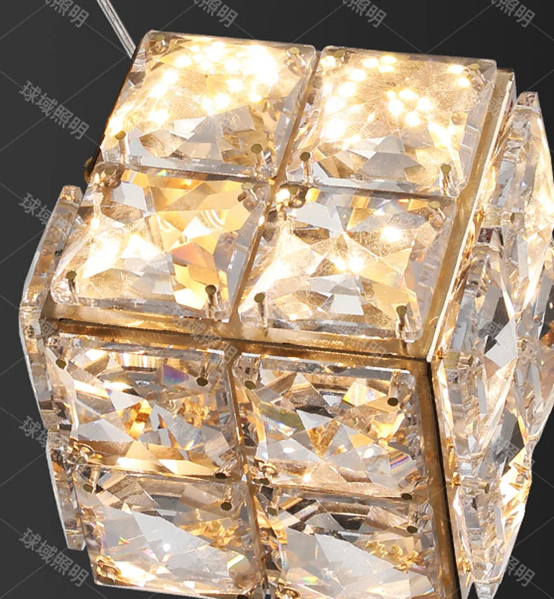 Crystal cube light fixture with gold accents on a dark background