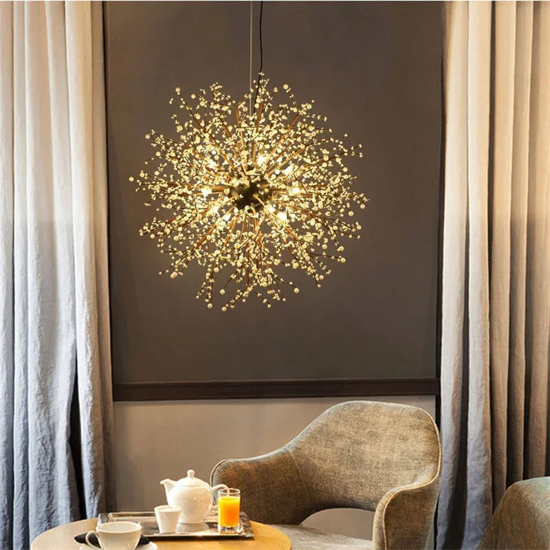 A bright, illuminated dandelion starburst pendant light with small white pearl accents, hanging above a seating area.