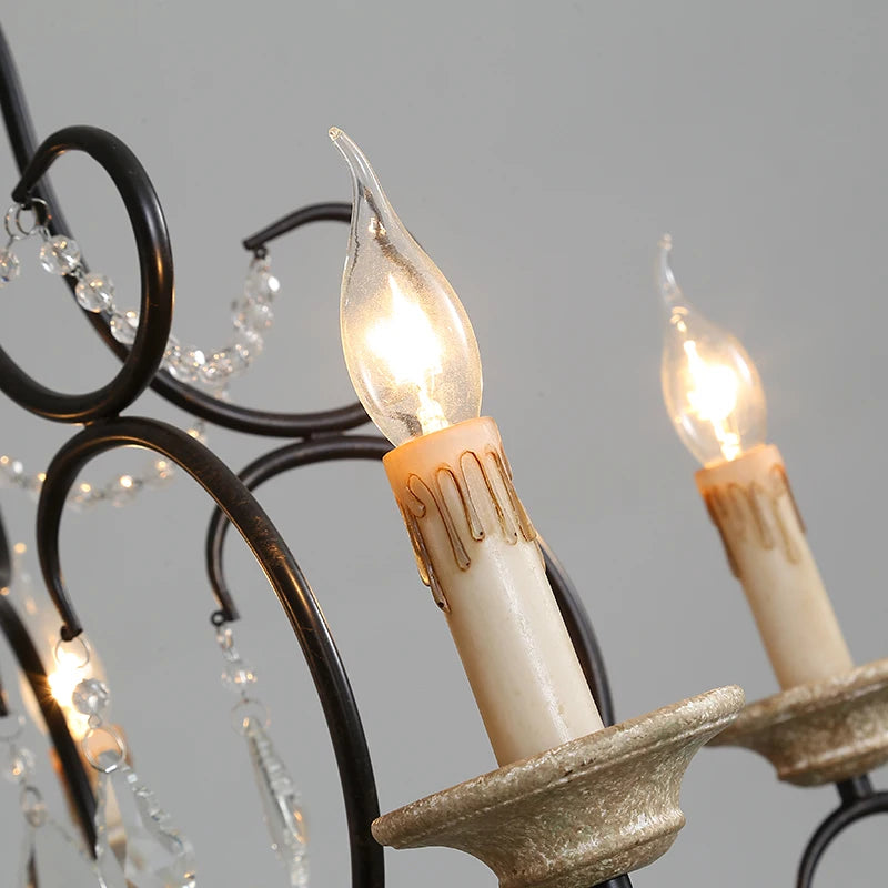 Close-up of the candle-style light sockets and faux candle sleeves on the black chandelier.
