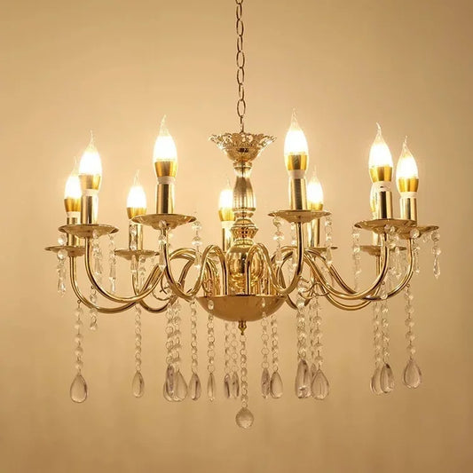 Close-up of the intricate gold metalwork and clear teardrop crystals on a waterfall chandelier.