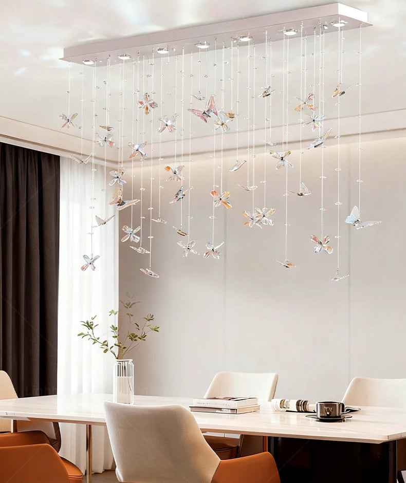 Modern chandelier with decorative elements in a dining room setting.
