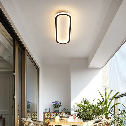 Ceiling light fixture in a modern interior setting with plants and furniture.