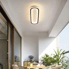 Ceiling light fixture in a modern interior setting with plants and furniture.