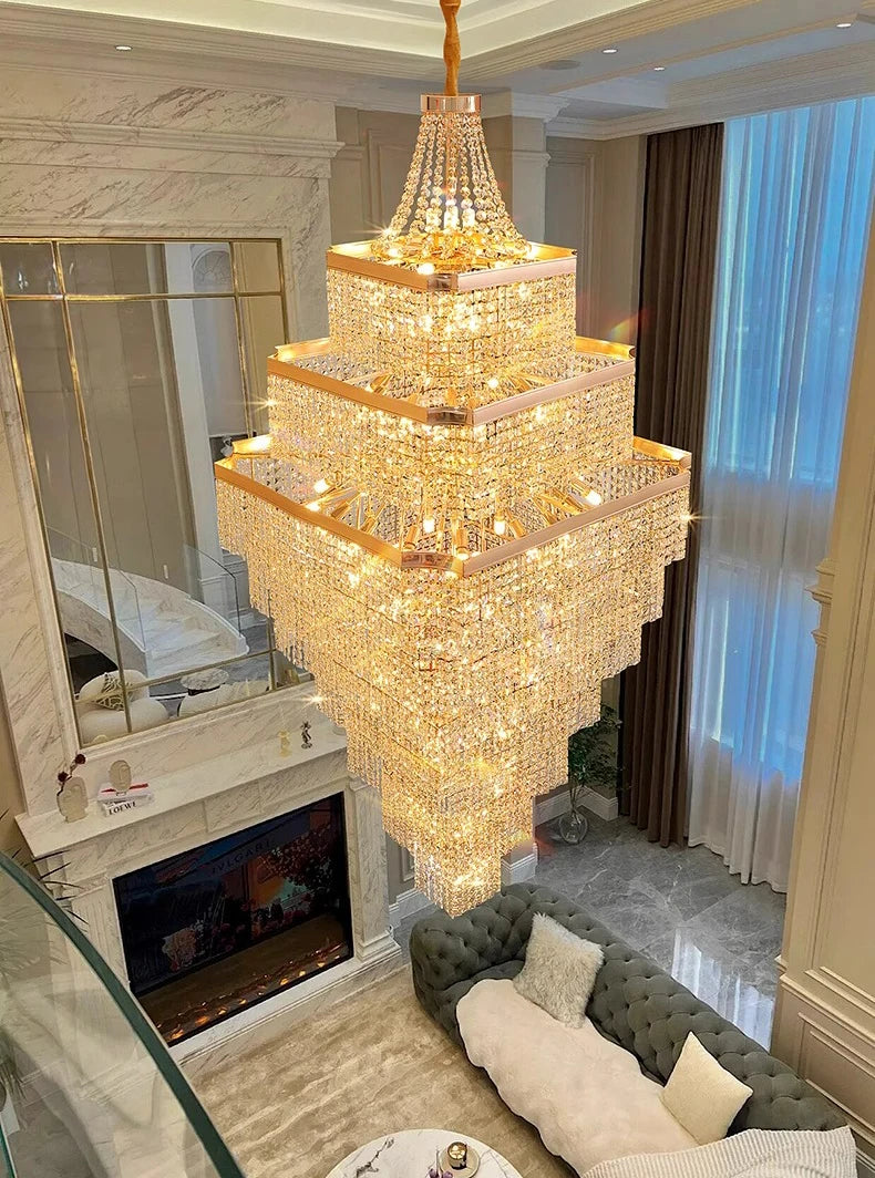 Luxurious chandelier hanging in a living room with a fireplace and sofa.