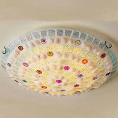 Detailed view of the colorful glass and shell mosaic pattern on a flush mount ceiling light.