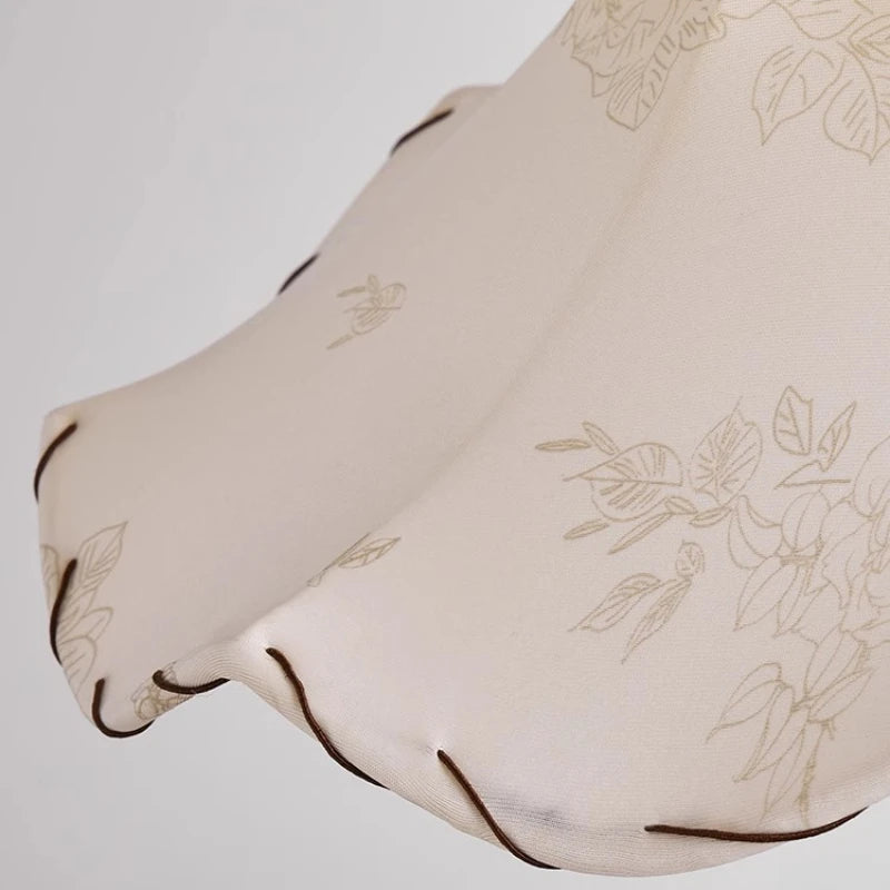 Beige fabric with floral embroidery on a light gray background