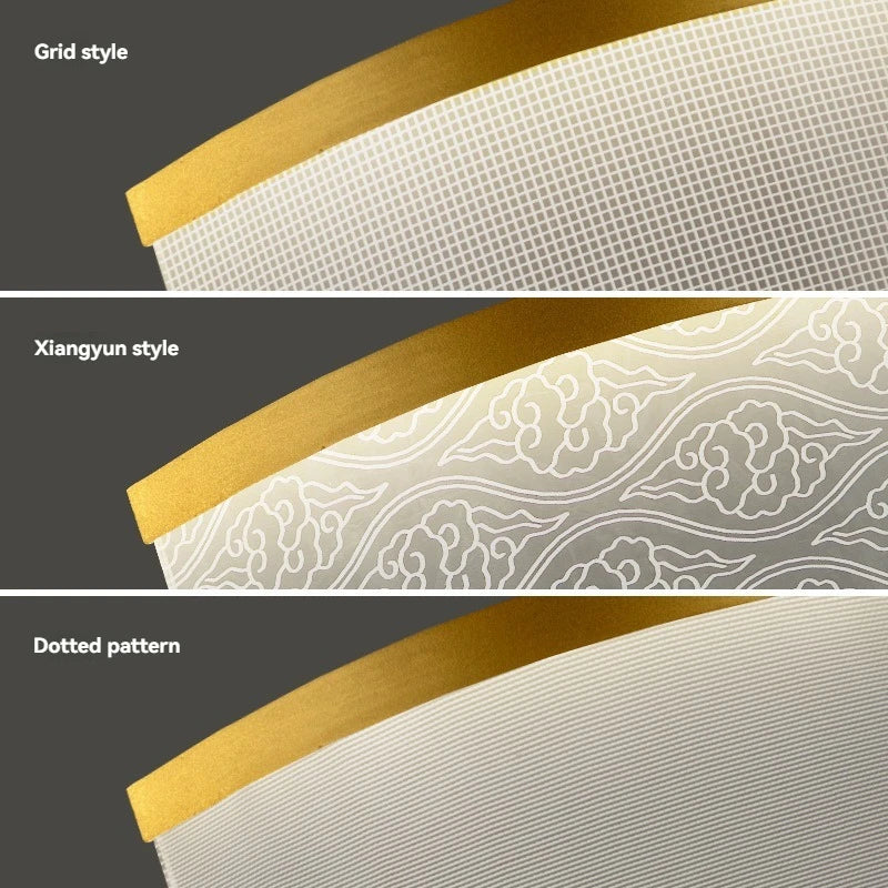 Three different patterns of a white fabric with gold trim on a gray background.