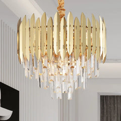 Side view of a gold and crystal tiered cascading chandelier in a well-lit room.