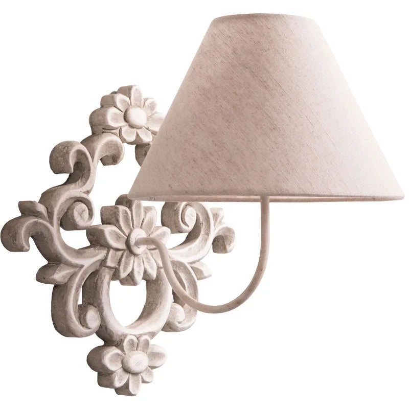 Decorative wall lamp with floral design on a white background.
