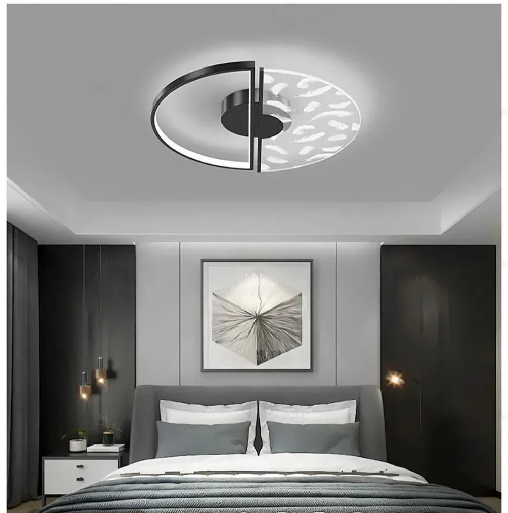 Modern bedroom with a ceiling light fixture, bed, and wall art.