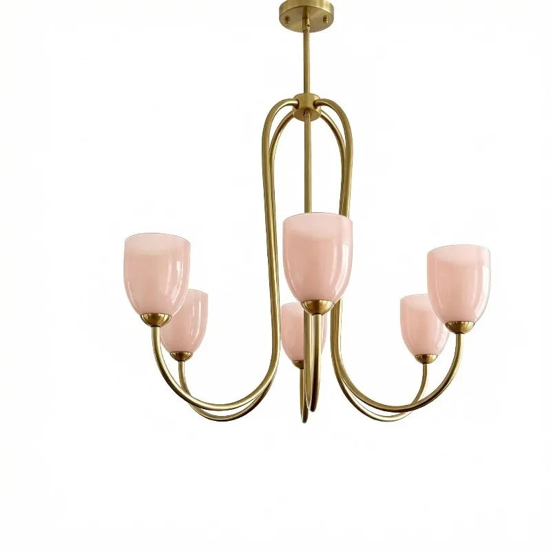 Close-up view of a brushed gold chandelier with five pink tulip glass shades against a white background.