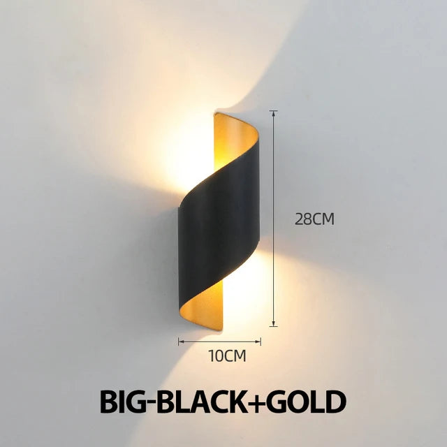Modern wall light fixture with black and gold design, dimensions indicated, on a gray background.