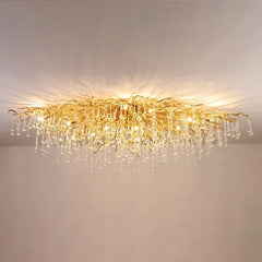 View of the gold crystal chandelier from a slightly different angle, showcasing its intricate design and sparkle.