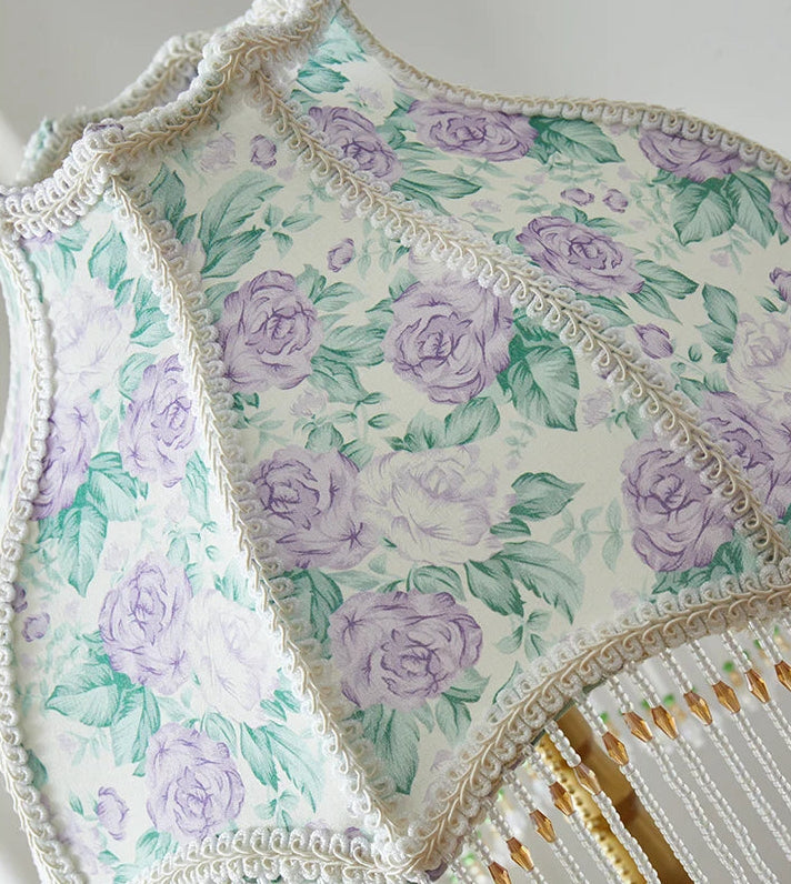 Floral patterned fabric with purple roses on a white background