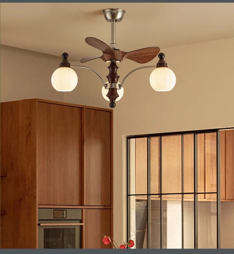 Ceiling fan with light fixture in a room with wooden cabinets and a window.