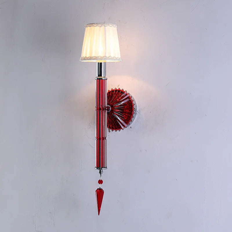 Wall-mounted lamp with red decorative elements on a white background