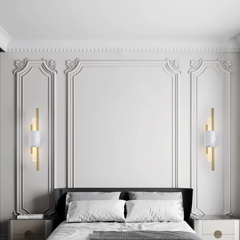 Decorative wall paneling with sconces in a bedroom setting