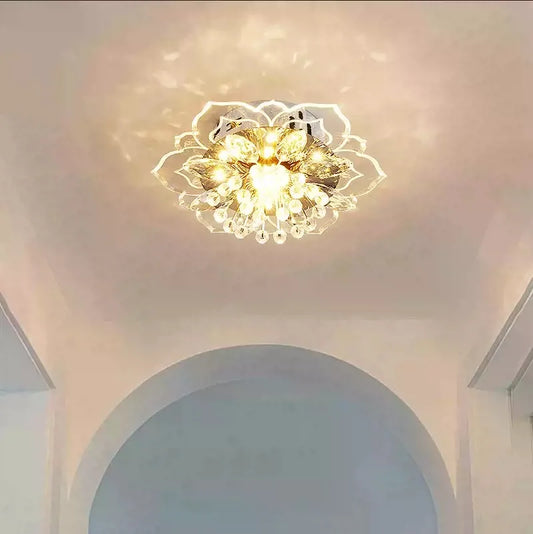 A single gold and crystal floral semi-flush ceiling light illuminating a white ceiling with decorative light patterns.