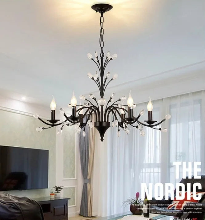 Black chandelier hanging in a living room.