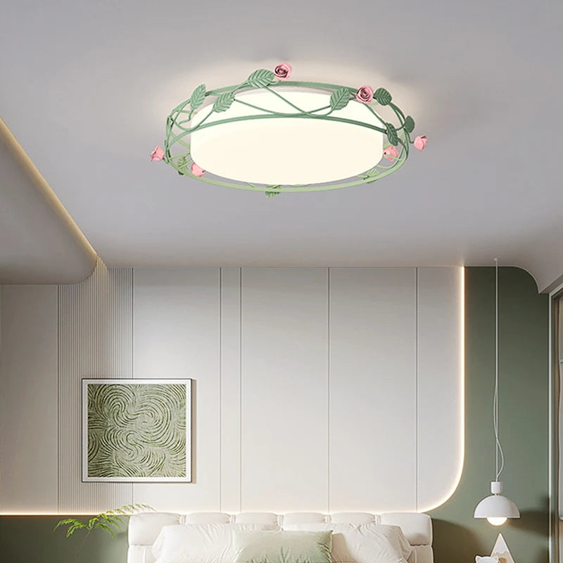 A green floral flush mount ceiling light installed in a bedroom above a bed.