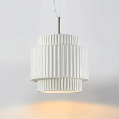 White tiered resin pendant light against a white background