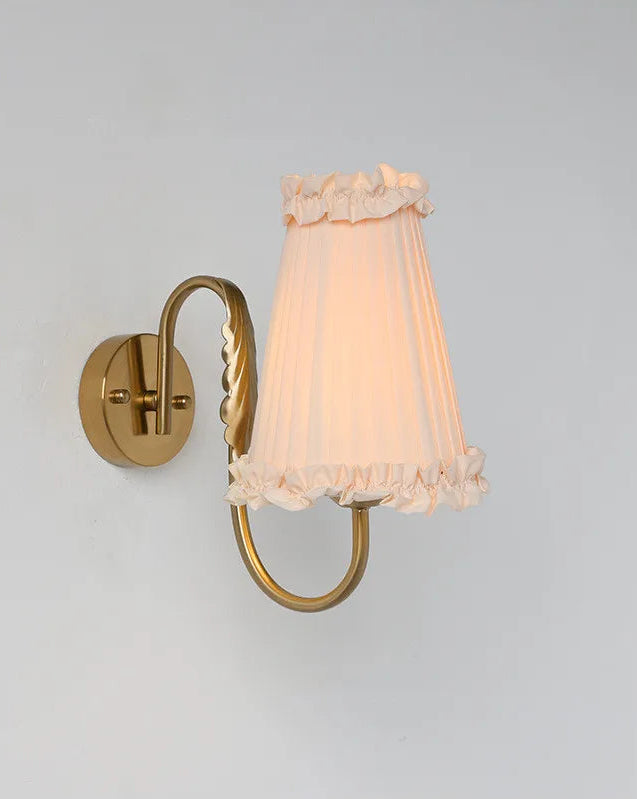 Warm ambient wall sconce with tassel-trim shade for bedroom or hallway lighting