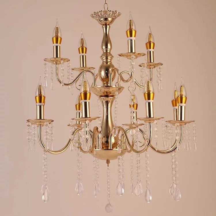 Close-up view of the central column and upper tier of a gold chandelier, showcasing intricate detailing and crystal embellishments.