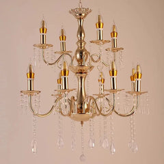 Close-up view of the central column and upper tier of a gold chandelier, showcasing intricate detailing and crystal embellishments.
