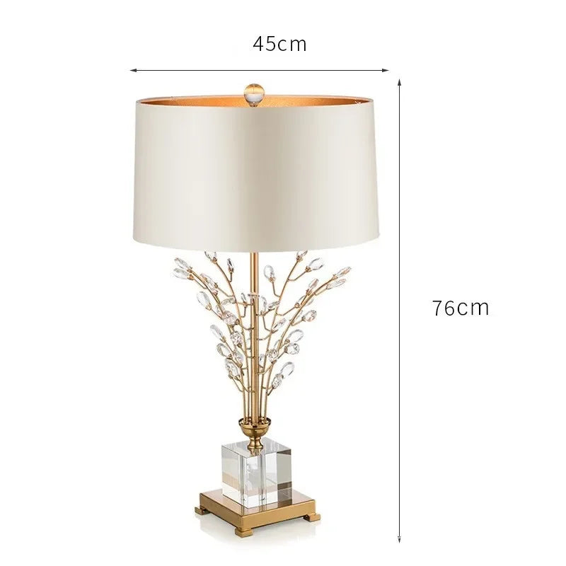 Table lamp with decorative branch design and measurements on a white background