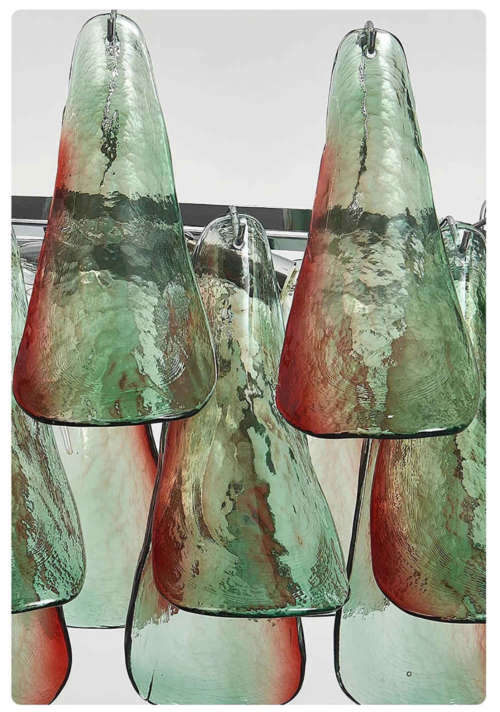 Set of glass pendant lights with a green and red marbled pattern on a white background