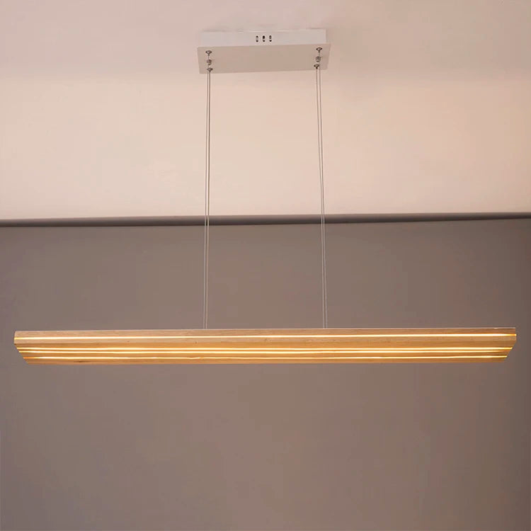 Modern pendant light fixture hanging against a neutral background