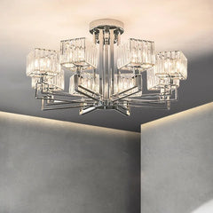 Close-up view of a polished chrome multi-arm chandelier with clear crystal shades illuminated.