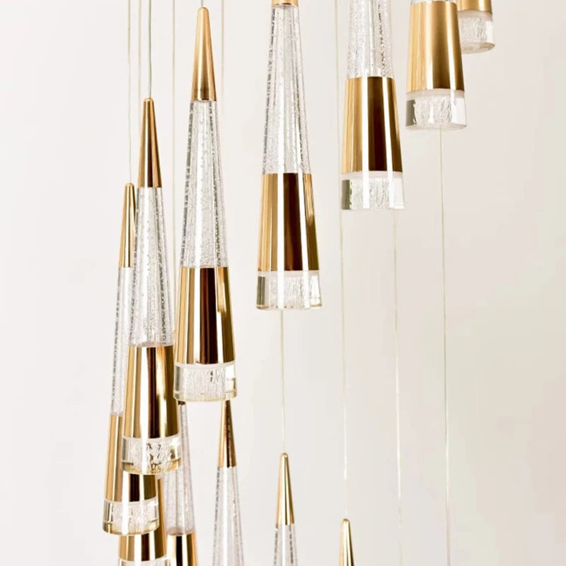 Gold and clear pendant lights on a white background