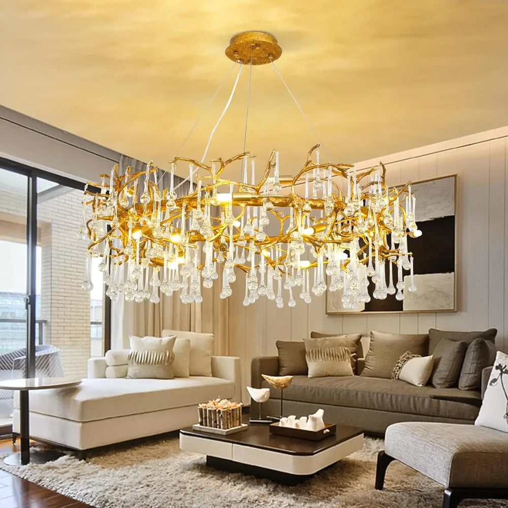 A wide view of a living room featuring a large gold branch crystal chandelier as the central light fixture.