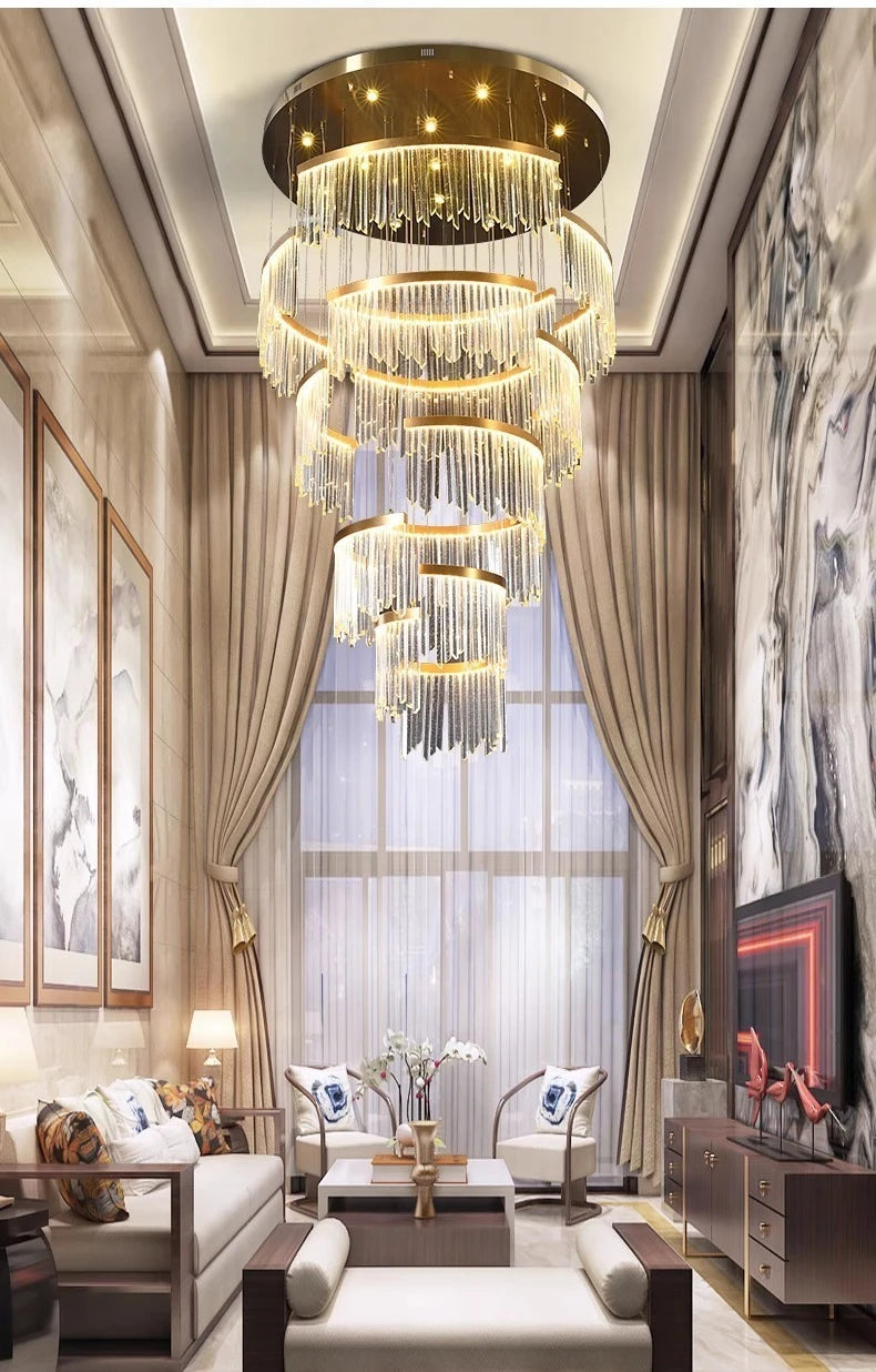 Luxurious living room with a grand chandelier, elegant decor, and large windows.