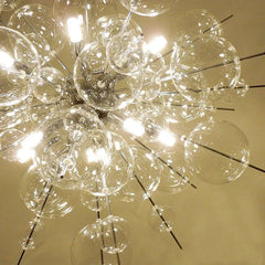 Detailed view of the glass spheres and LED lights within a starburst chandelier, highlighting the intricate construction and reflective surfaces.