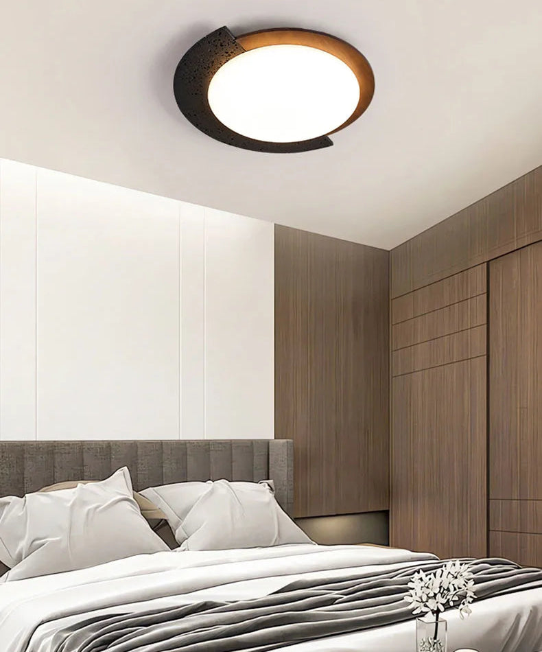 Ceiling light fixture in a bedroom setting with bed and wardrobe.