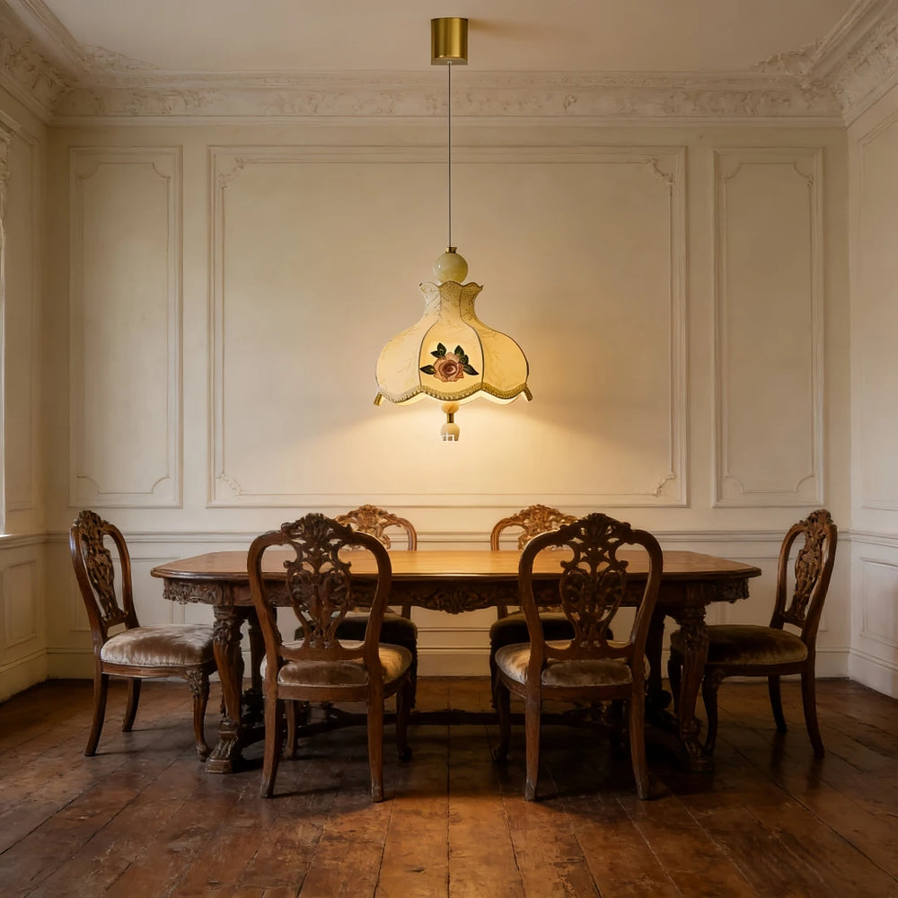 Champagne fabric pendant light with floral rose embroidery illuminating a wooden dining table and chairs.