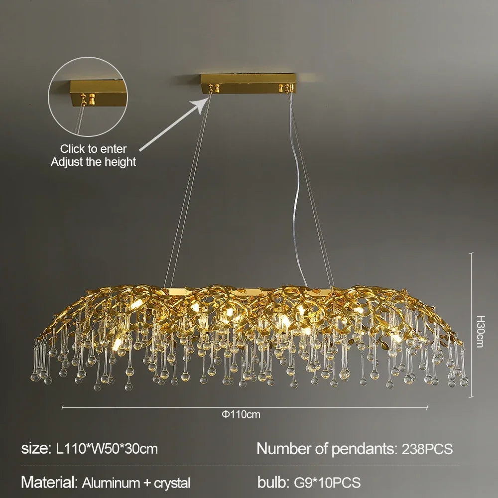 Gold chandelier with crystal pendants on a dark background, showing adjustable height feature.
