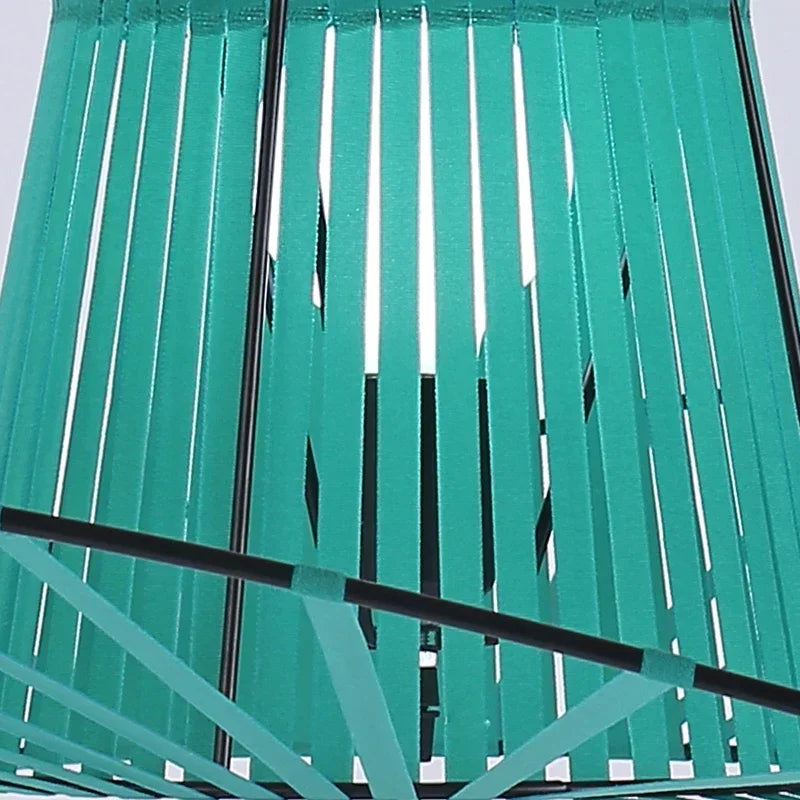 Close-up of green metal slats with a white background.